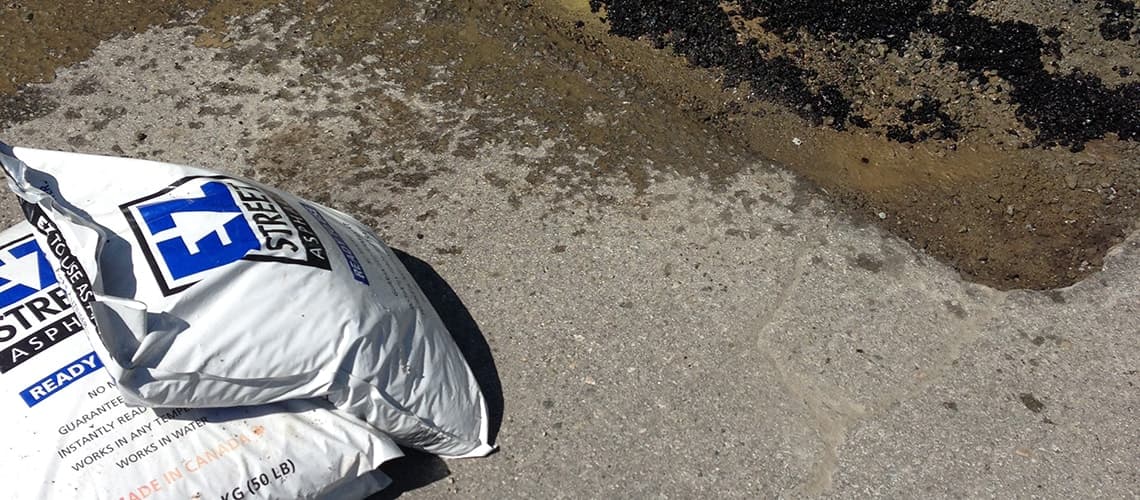 EZ Street bag next to pothole repair